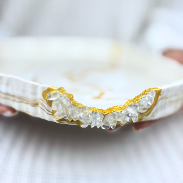 Close-up of Serenity Jesmonite Bowl featuring golden marbled finish, Kintsugi-inspired detailing, and clear quartz crystal embellishments, handcrafted in Dubai, UAE.