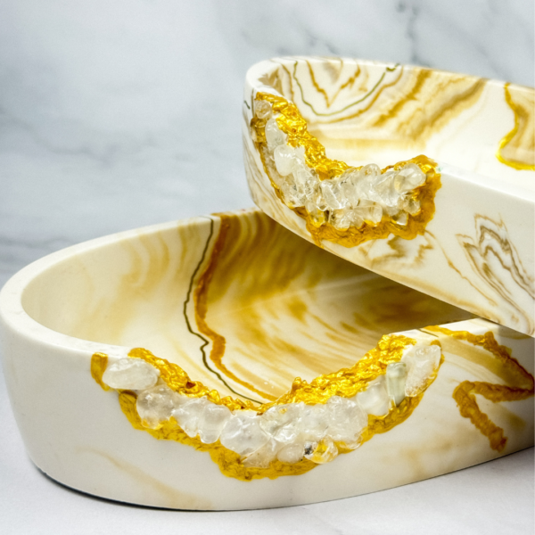 Stacked Terra Wave Jesmonite Jewelry Storage pieces with golden marbled design, Kintsugi-inspired details, and clear quartz crystal accents, handcrafted in Dubai, UAE.