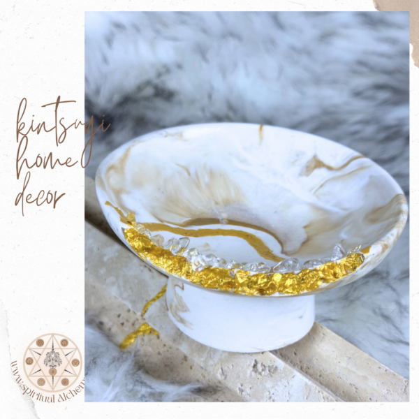 Stylized jesmonite Luminous Alchemy Pedestal Bowl with golden marbled finish, Kintsugi-inspired detailing, and clear quartz accents, handcrafted in Dubai, UAE.